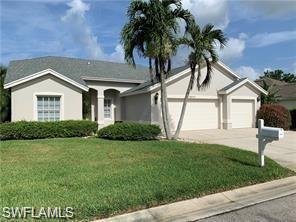 22171 Seashore Circle Estero, FL 33928 - Photo 1 of 16 a front view of a house with a garden and yard