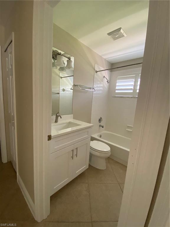 22171 Seashore Circle Estero, FL 33928 - Photo 12 of 16 a bathroom with a granite countertop toilet a sink and a mirror