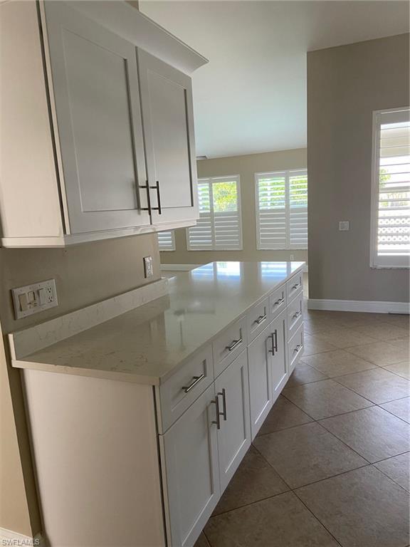22171 Seashore Circle Estero, FL 33928 - Photo 3 of 16 a kitchen with granite countertop white cabinets and sink