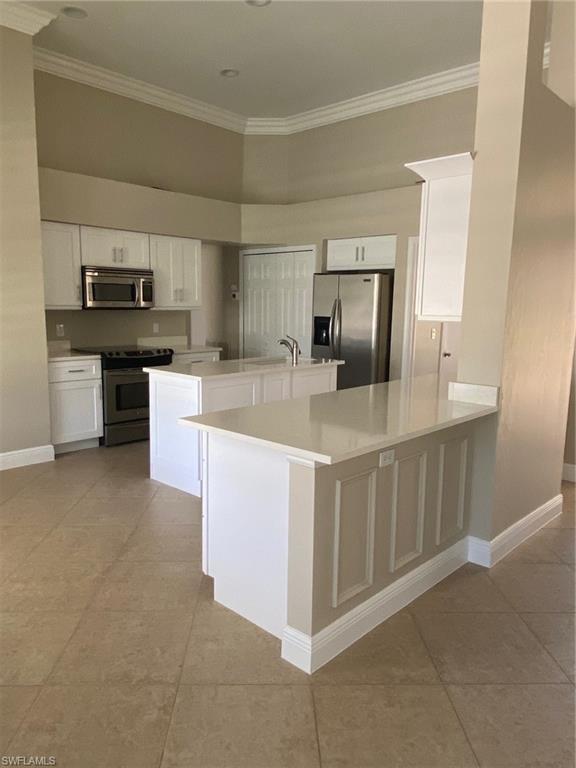 22171 Seashore Circle Estero, FL 33928 - Photo 5 of 16 a kitchen with stainless steel appliances granite countertop a sink counter space cabinets and a stove