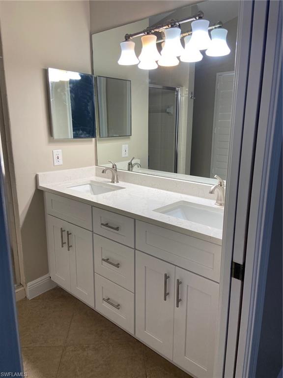 22171 Seashore Circle Estero, FL 33928 - Photo 9 of 16 a bathroom with a double vanity sink and mirror