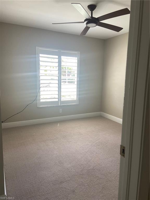 22171 Seashore Circle Estero, FL 33928 - Photo 10 of 16 an empty room with a window and a fan