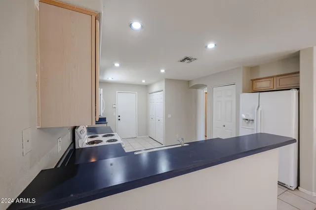 a large kitchen with stainless steel appliances a large counter top and a stove