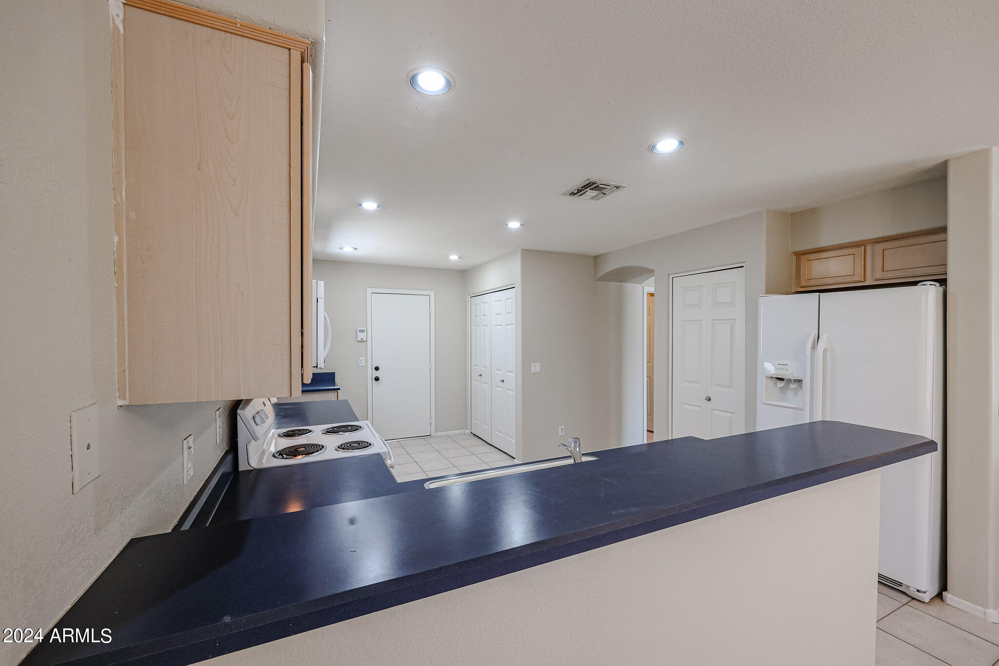 6921 West Juniper Avenue Peoria, AZ 85382 - Photo 11 of 33 a large kitchen with stainless steel appliances a large counter top and a stove
