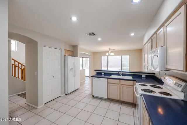 a kitchen with stainless steel appliances granite countertop a sink and cabinets