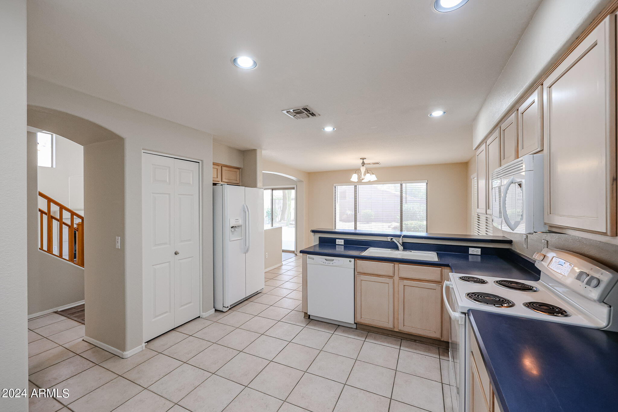 6921 West Juniper Avenue Peoria, AZ 85382 - Photo 13 of 33 a kitchen with stainless steel appliances granite countertop a sink and cabinets