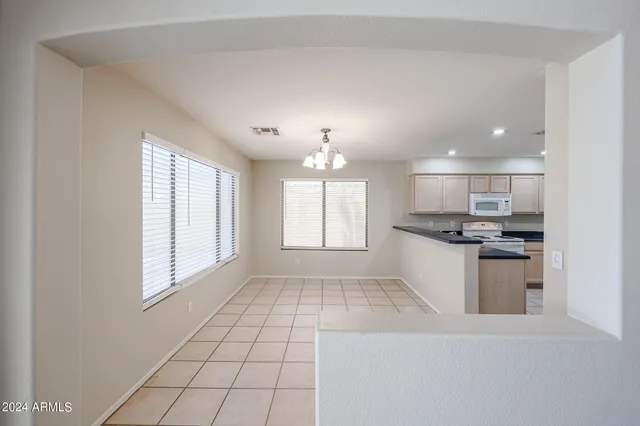 a kitchen with kitchen island granite countertop a stove and a sink