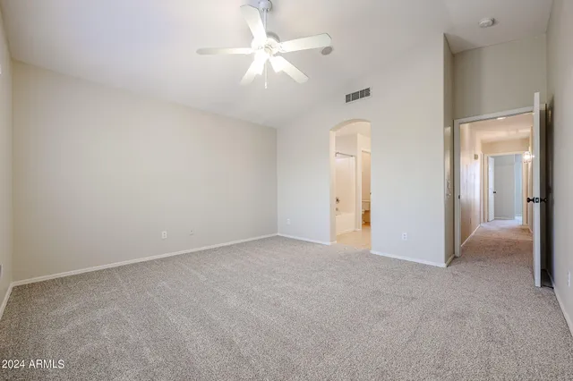 an empty room with fan and entrance