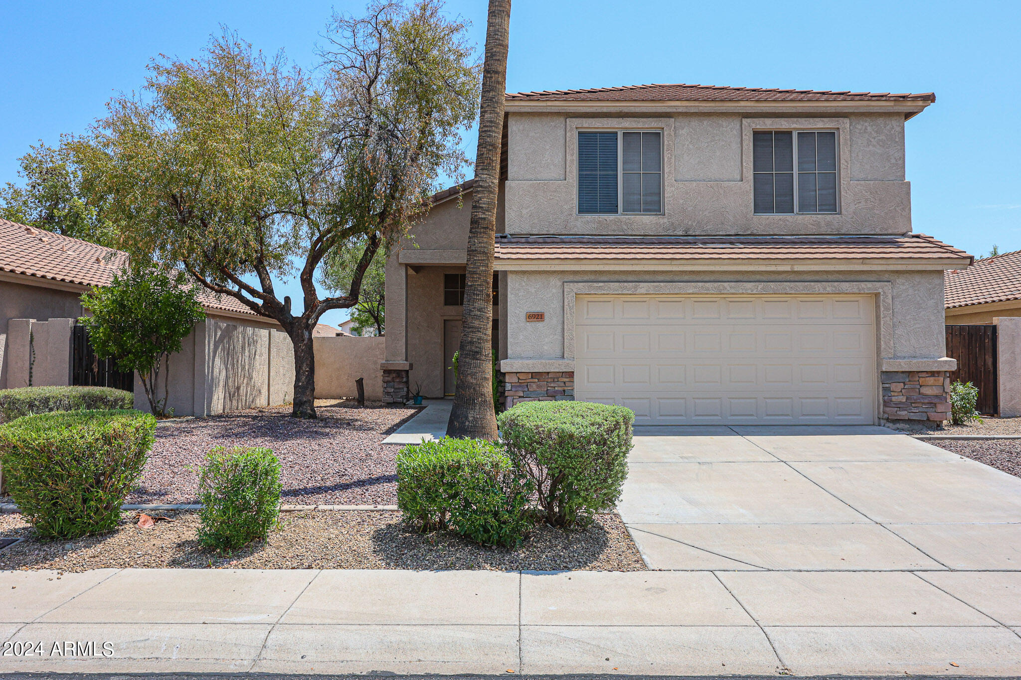 6921 West Juniper Avenue Peoria, AZ 85382 - Photo 2 of 33 a front view of a house with garden