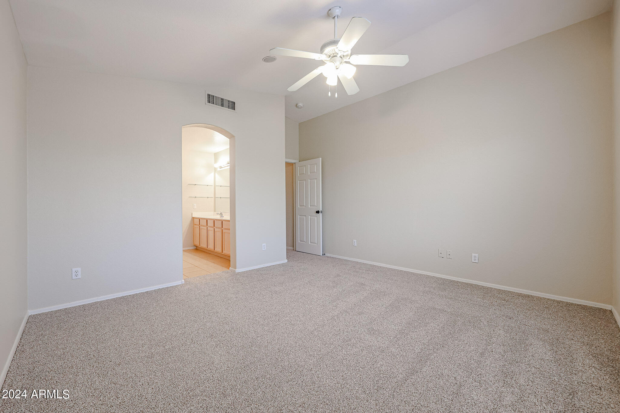 6921 West Juniper Avenue Peoria, AZ 85382 - Photo 21 of 33 an empty room with chandelier fan and windows