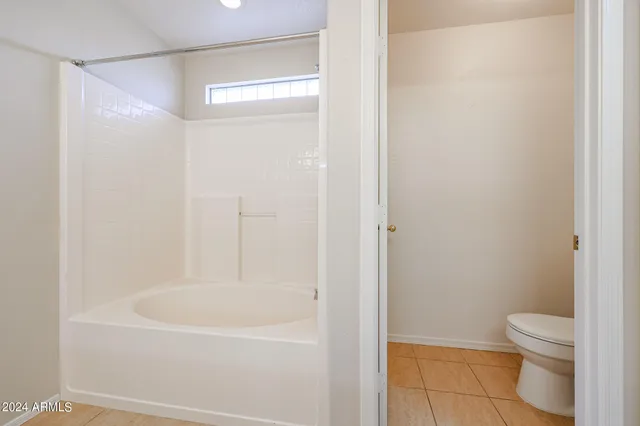 a white bath tub sitting next to a white toilet