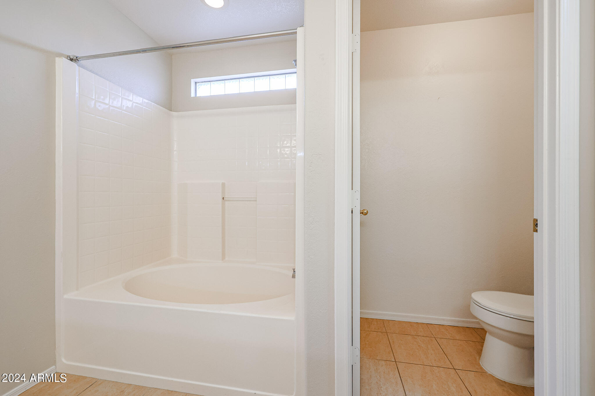 6921 West Juniper Avenue Peoria, AZ 85382 - Photo 23 of 33 a white bath tub sitting next to a white toilet