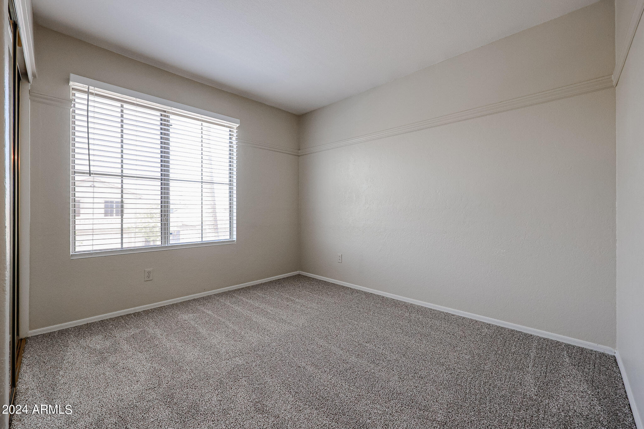 6921 West Juniper Avenue Peoria, AZ 85382 - Photo 28 of 33 an empty room with a window