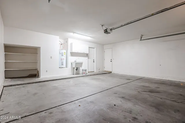 a view of a room with wooden floor and a large tree