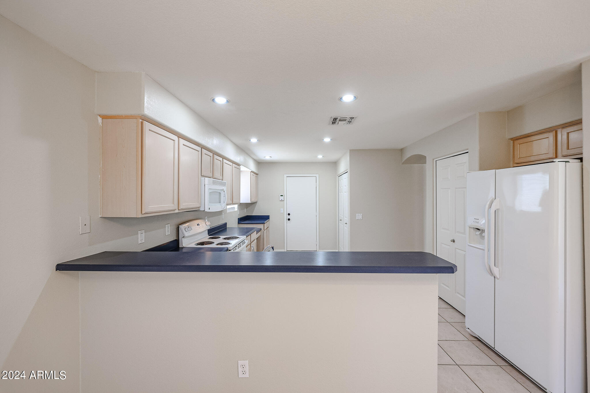 6921 West Juniper Avenue Peoria, AZ 85382 - Photo 10 of 33 a kitchen with stainless steel appliances granite countertop a refrigerator a sink and a stove