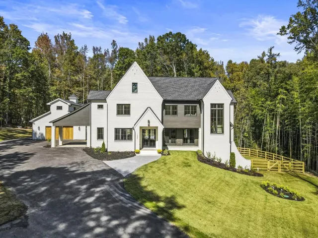 a front view of a house with a yard table and chairs