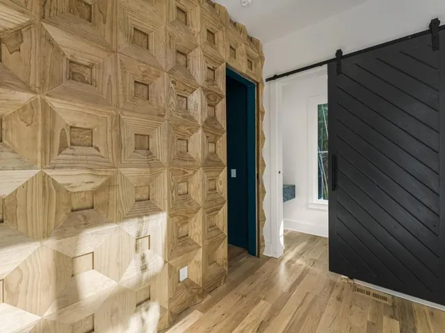 a room with chandelier fan and a window