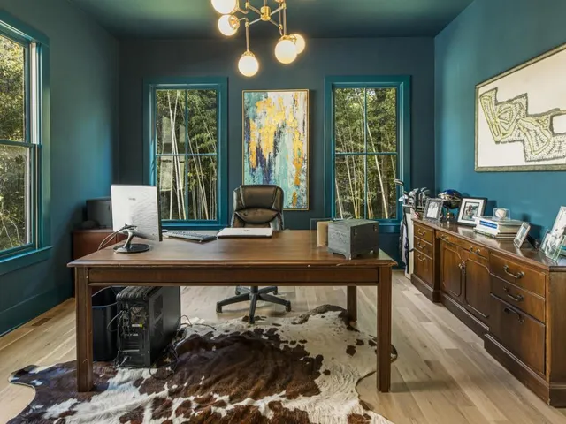 a bathroom with a granite countertop sink toilet mirror and shower