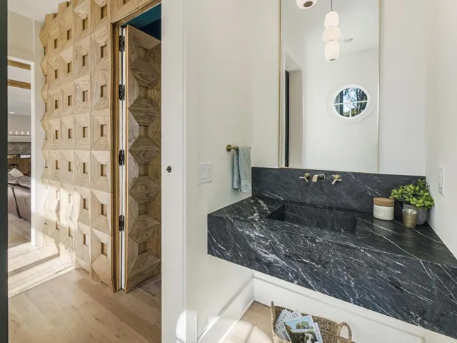 a view of a livingroom with wooden floor and stairs