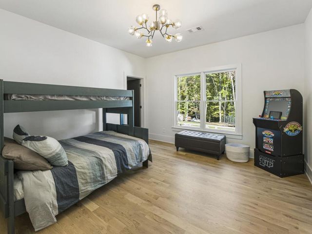 a bedroom with a bed and wooden floor
