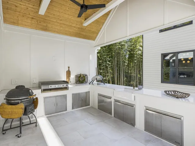 a view of a house with backyard and sitting area