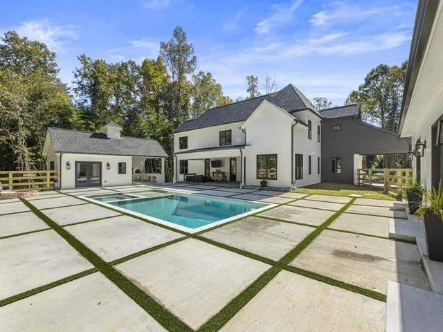 a view of a house with sitting area and swimming pool