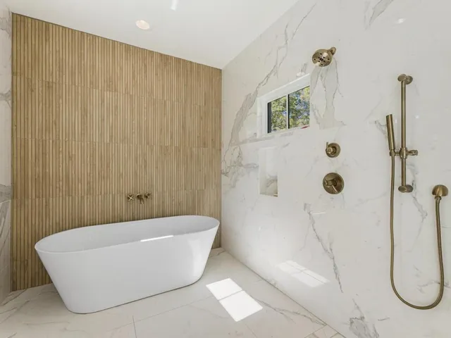 a bathroom with a bathtub and shower