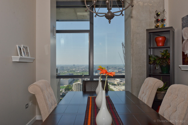 235 West Van Buren Street, Unit 3311 Chicago, IL 60607 - Photo 15 of 23 a living room with furniture and a floor to ceiling window