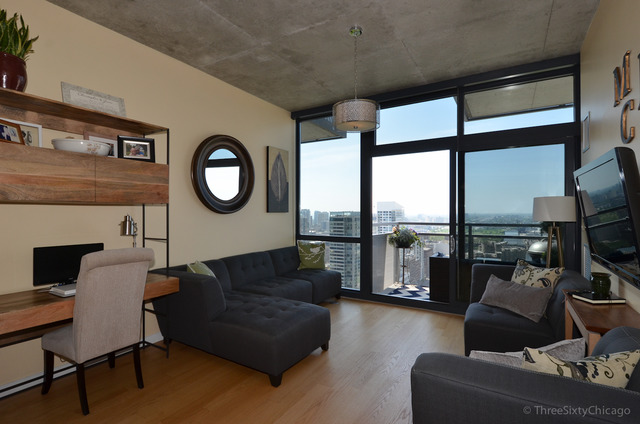 235 West Van Buren Street, Unit 3311 Chicago, IL 60607 - Photo 3 of 23 a living room with furniture and a floor to ceiling window