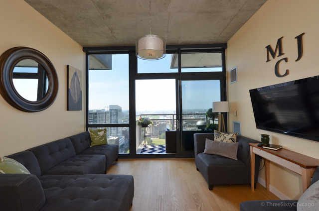 235 West Van Buren Street, Unit 3311 Chicago, IL 60607 - Photo 4 of 23 a living room with furniture and a flat screen tv