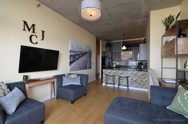 235 West Van Buren Street, Unit 3311 Chicago, IL 60607 - Photo 6 of 23 a living room with furniture and a flat screen tv