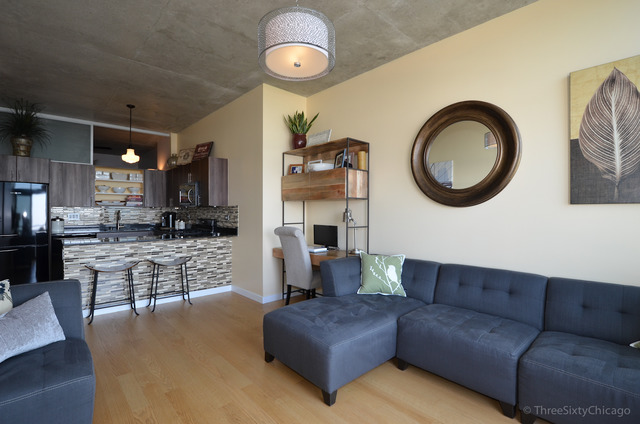 235 West Van Buren Street, Unit 3311 Chicago, IL 60607 - Photo 9 of 23 a living room with furniture a fireplace and kitchen view