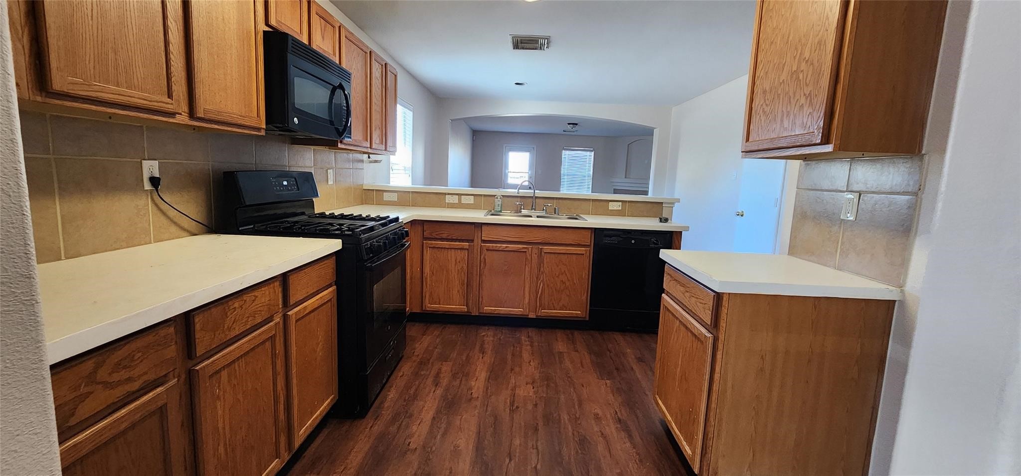 315 Sunset Colony Drive Rosharon, TX 77583 - Photo 5 of 20 a kitchen with stainless steel appliances granite countertop refrigerator a sink and wooden cabinets