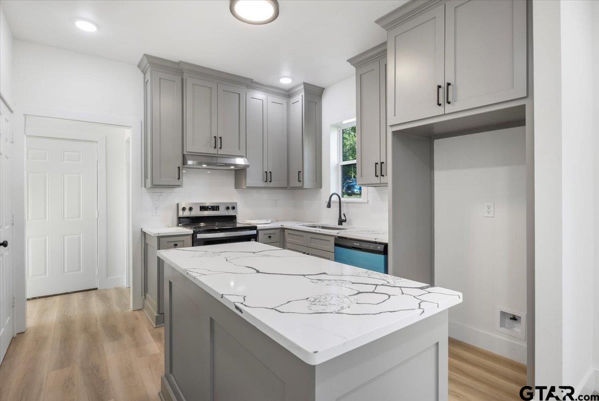 6600 Lionheart Drive Tyler, TX 75708 - Photo 11 of 32 a kitchen with stainless steel appliances granite countertop a sink stove and refrigerator