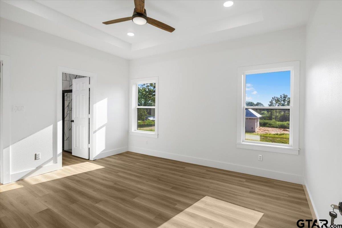 6600 Lionheart Drive Tyler, TX 75708 - Photo 12 of 32 a view of an empty room with window and wooden floor