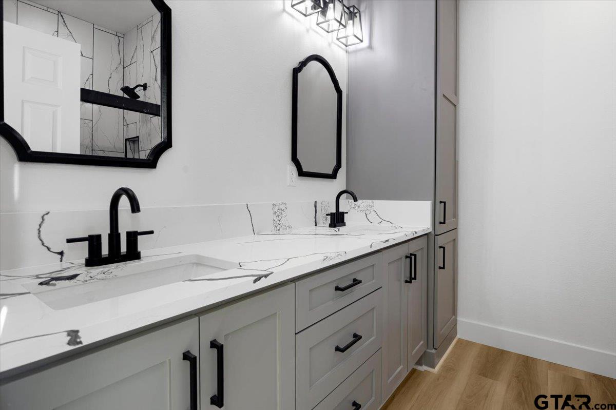 6600 Lionheart Drive Tyler, TX 75708 - Photo 15 of 32 a bathroom with a double vanity sink and a mirror