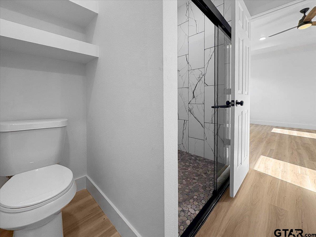 6600 Lionheart Drive Tyler, TX 75708 - Photo 17 of 32 a bathroom with a toilet and shower