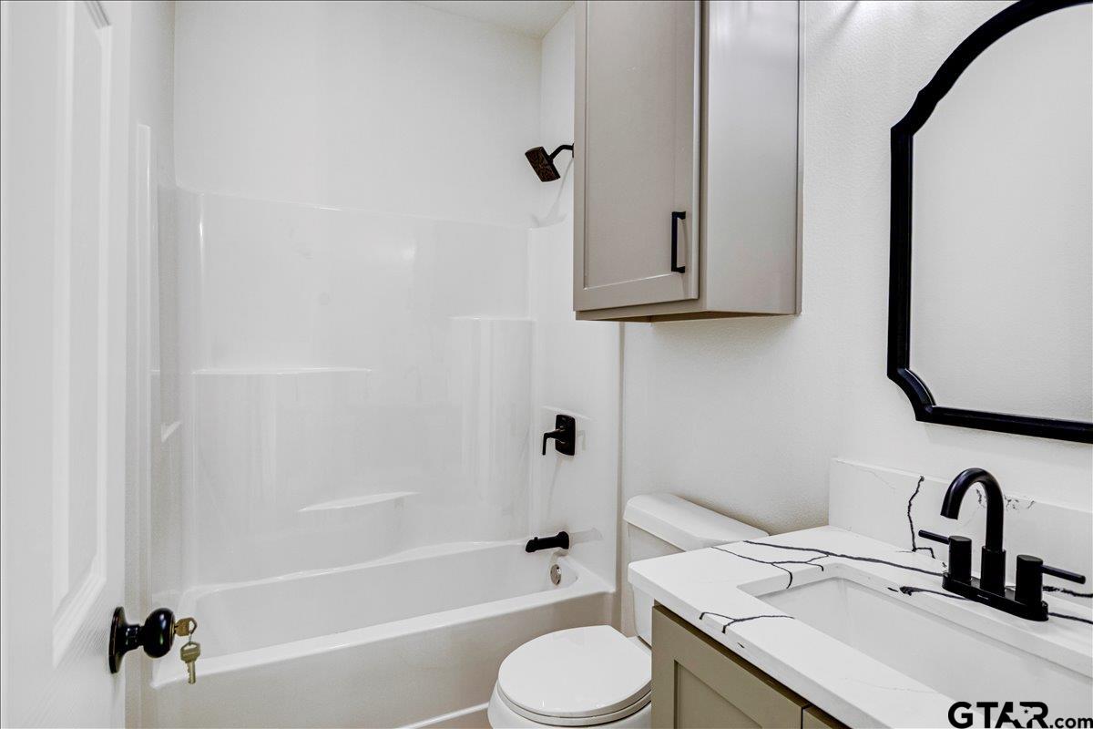 6600 Lionheart Drive Tyler, TX 75708 - Photo 22 of 32 a bathroom with a sink toilet and shower