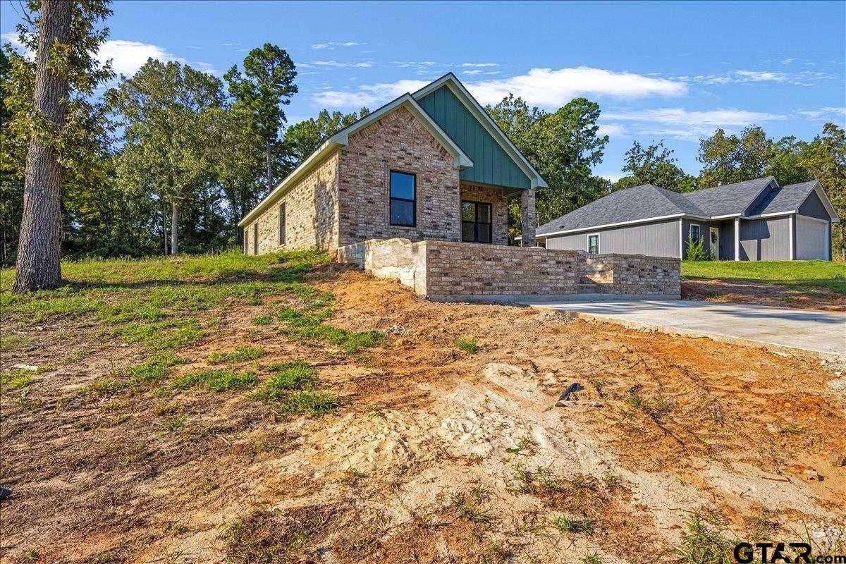 6600 Lionheart Drive Tyler, TX 75708 - Photo 3 of 32 a front view of a house with a yard
