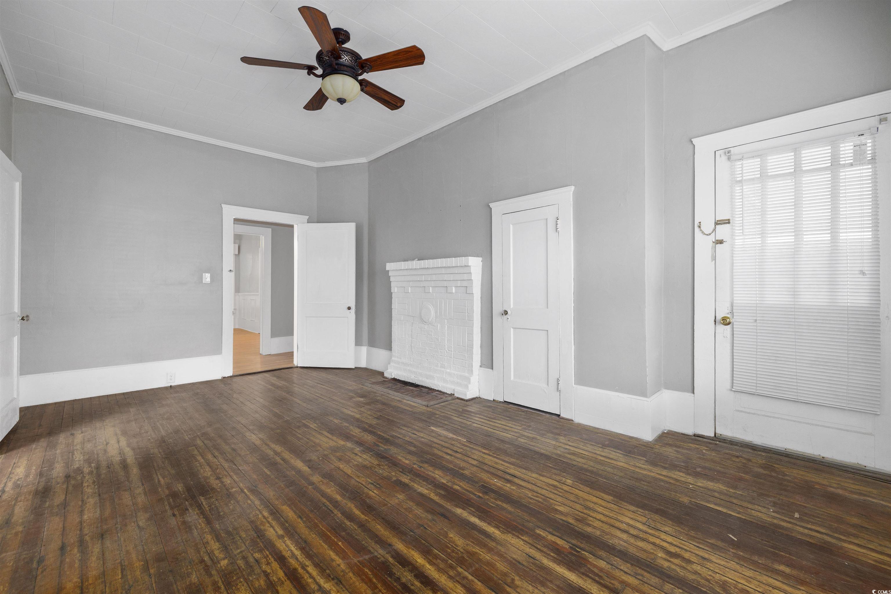 205 South Nichols Street Nichols, SC 29581 - Photo 14 of 27 Interior space with ceiling fan, crown molding, and dark wood-type flooring