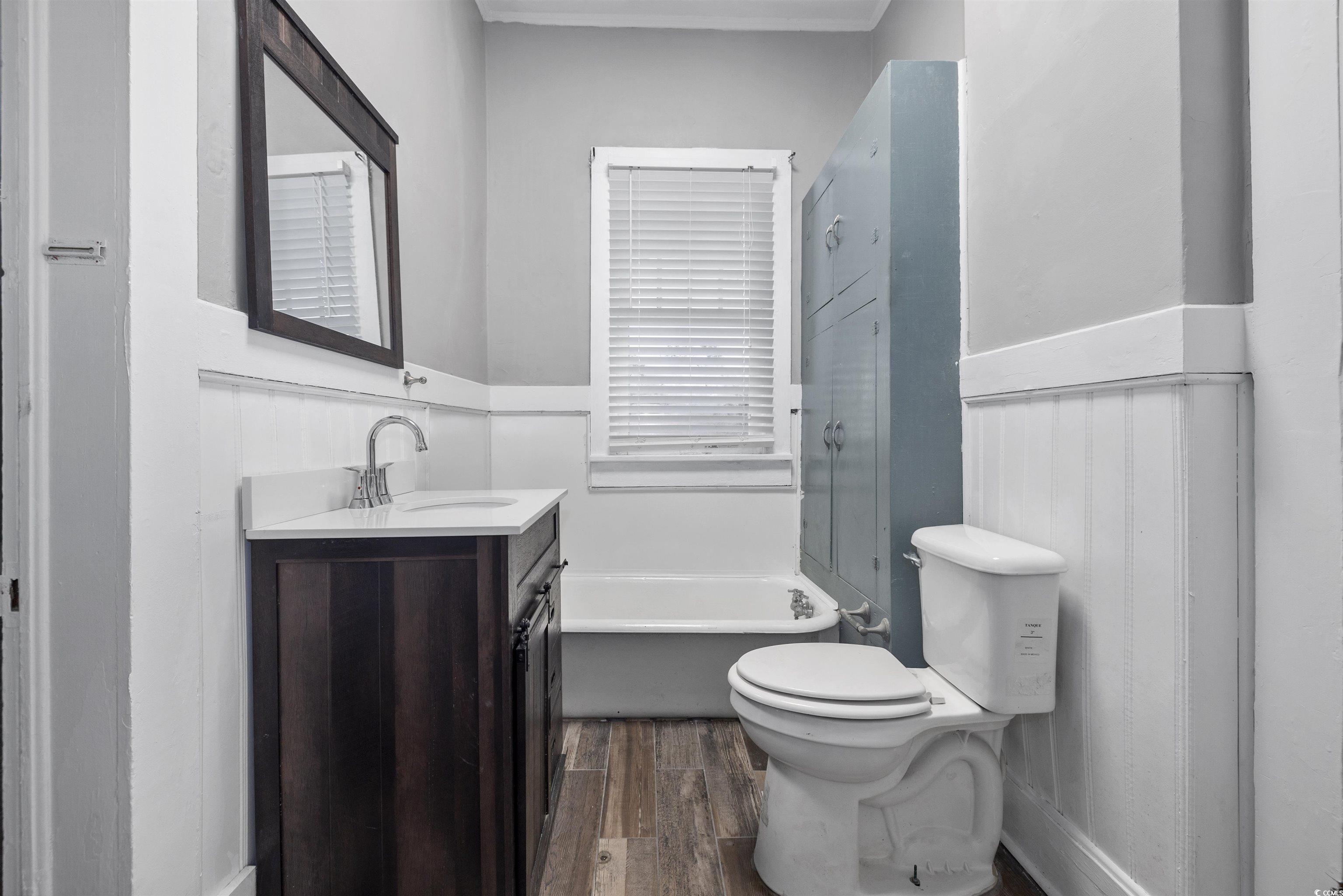 205 South Nichols Street Nichols, SC 29581 - Photo 16 of 27 Bathroom with hardwood / wood-style flooring, vanity, toilet, and a tub