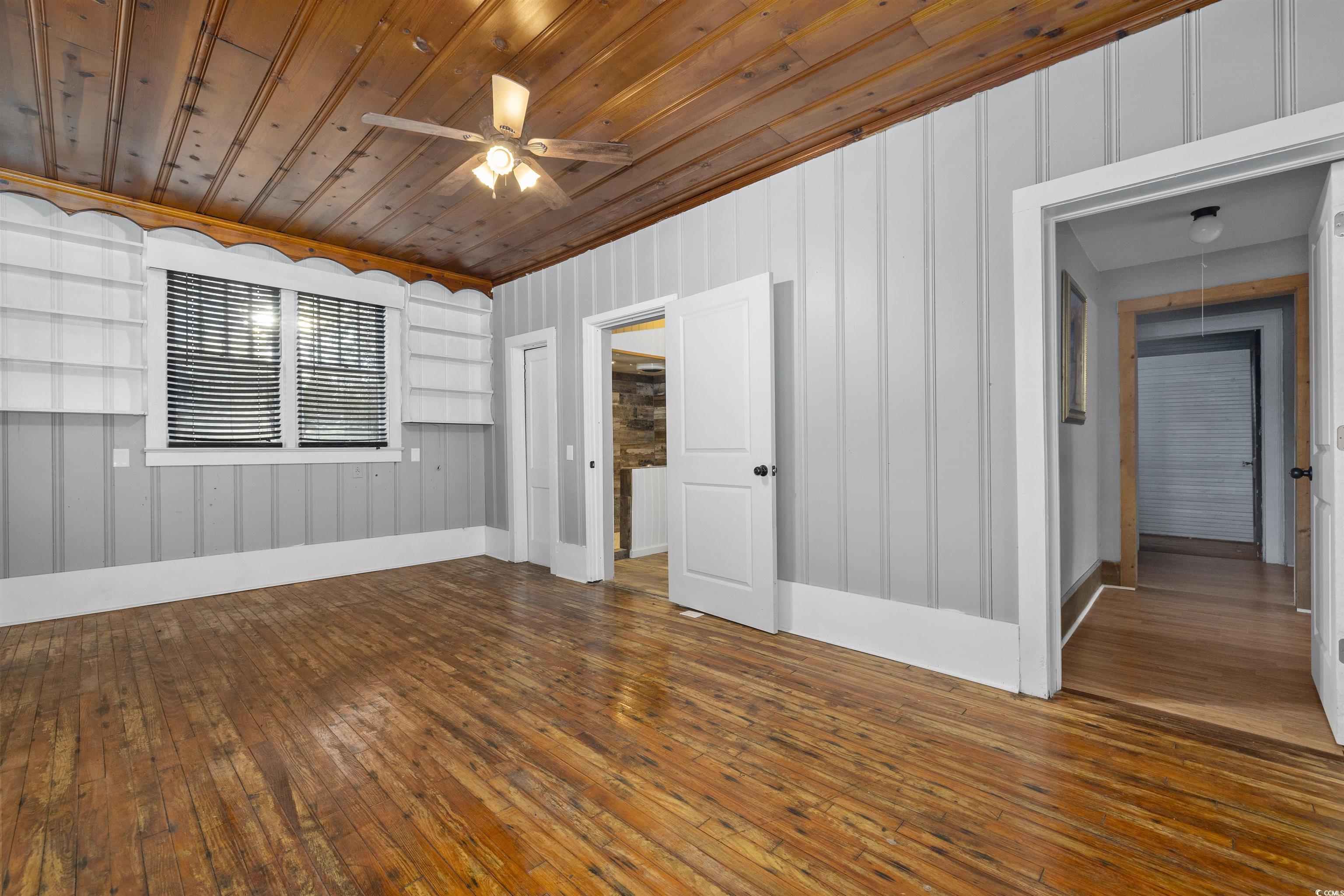 205 South Nichols Street Nichols, SC 29581 - Photo 18 of 27 Unfurnished room featuring wooden walls, hardwood / wood-style flooring, ceiling fan, and wooden ceiling