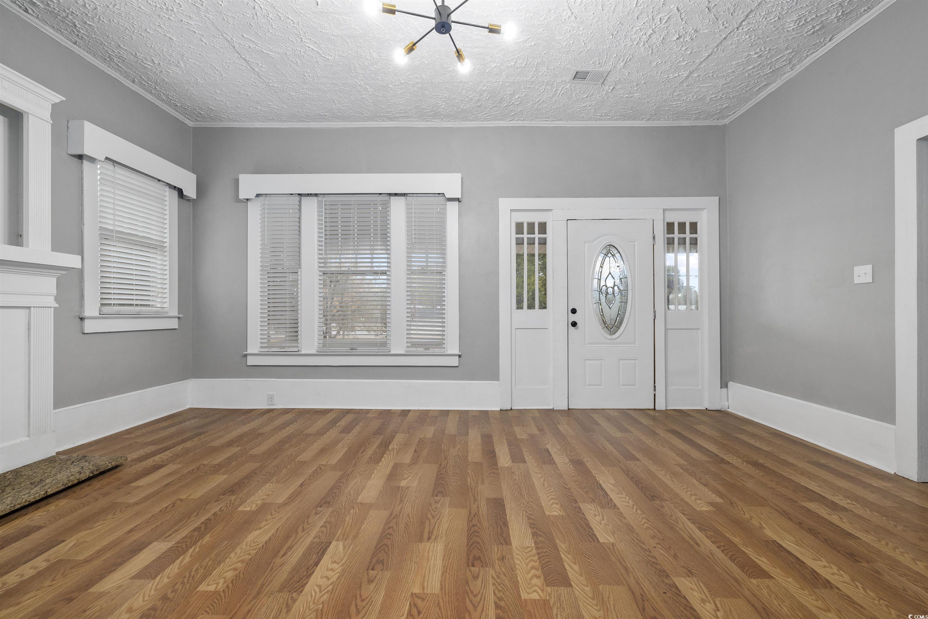 205 South Nichols Street Nichols, SC 29581 - Photo 2 of 27 Entrance foyer with hardwood / wood-style floors and a textured ceiling