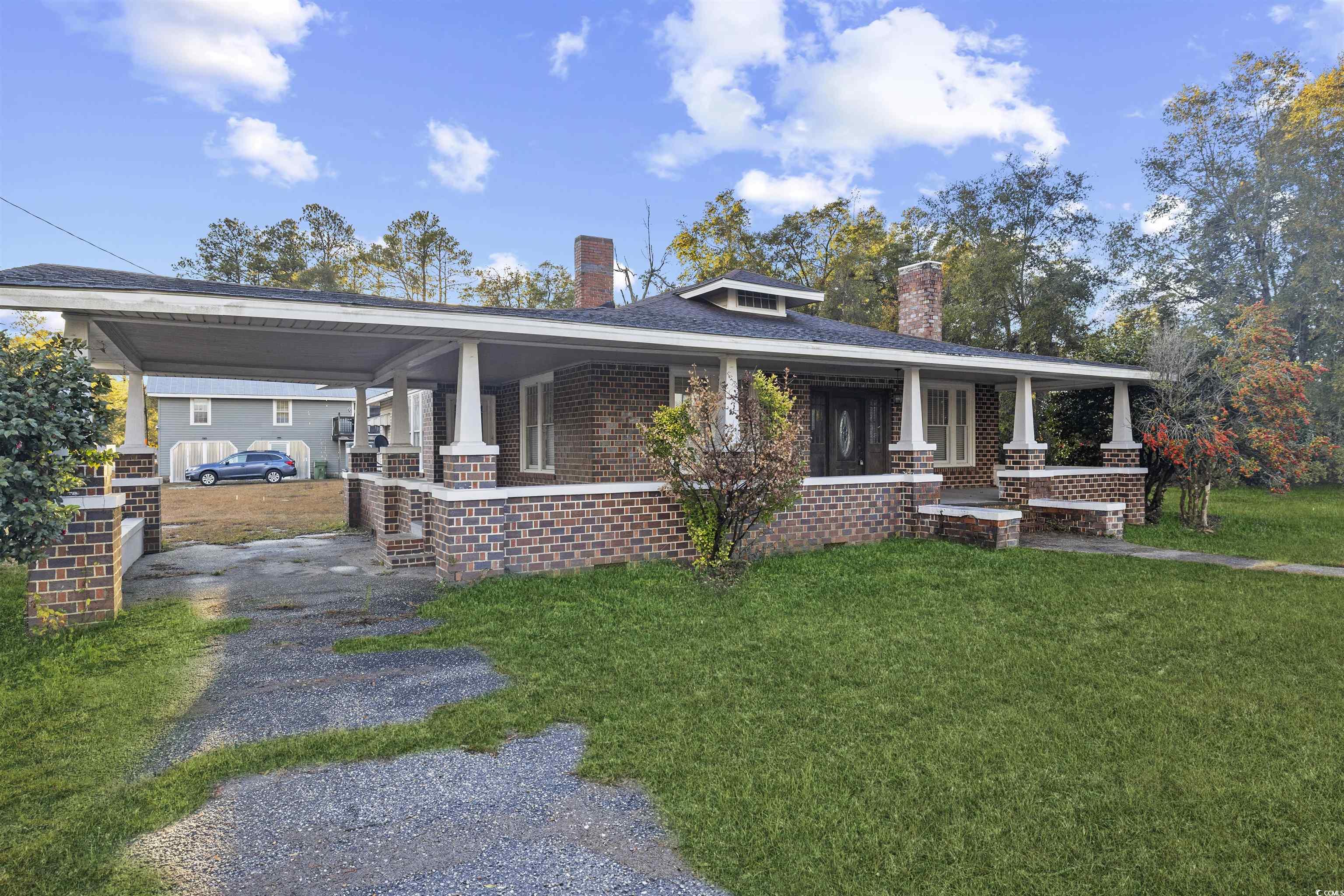 205 South Nichols Street Nichols, SC 29581 - Photo 24 of 27 View of front facade featuring covered porch and a front lawn