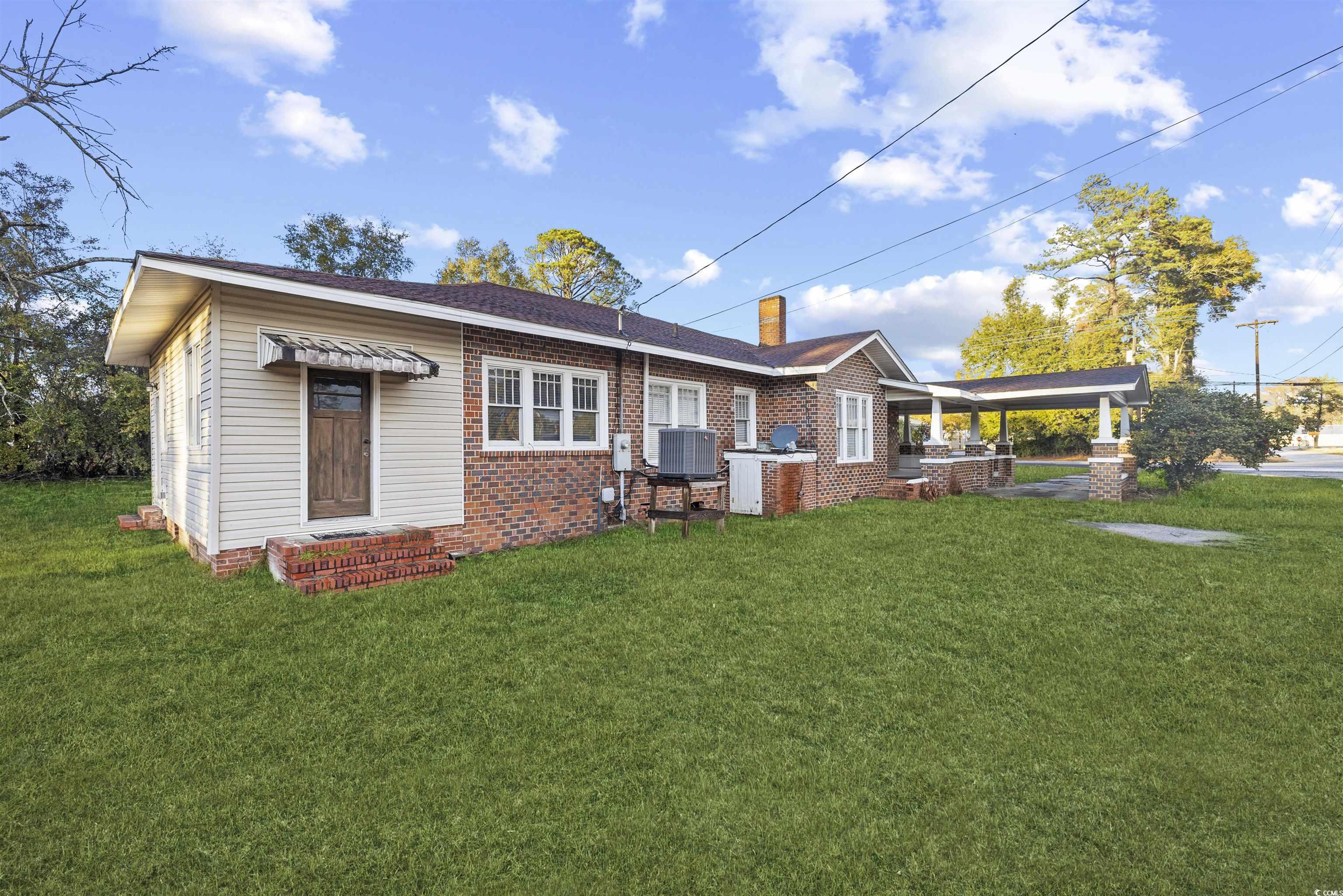 205 South Nichols Street Nichols, SC 29581 - Photo 25 of 27 Rear view of property with a yard and central AC