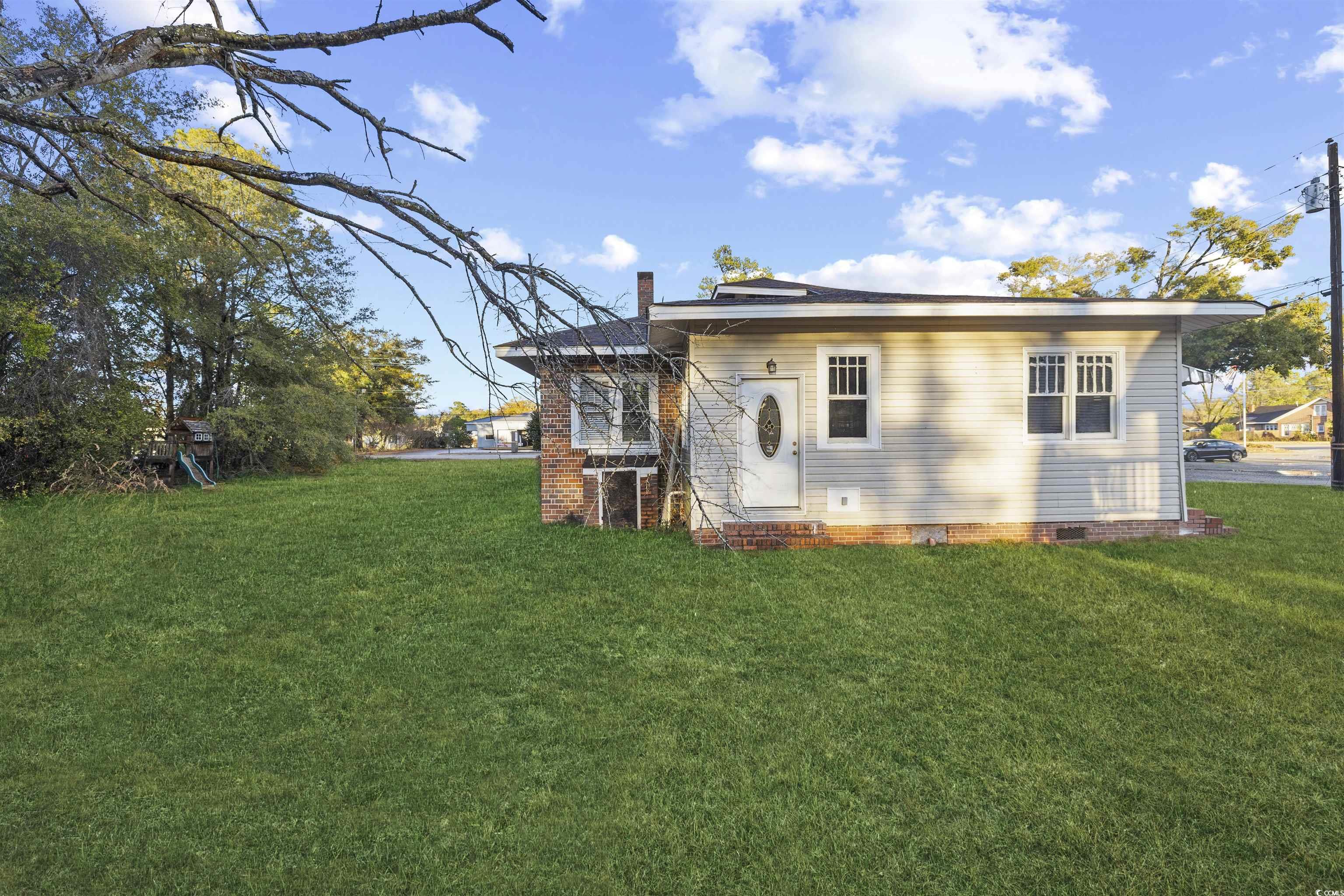 205 South Nichols Street Nichols, SC 29581 - Photo 26 of 27 Rear view of house featuring a yard