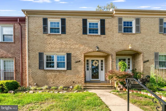 a front view of a house with outdoor seating