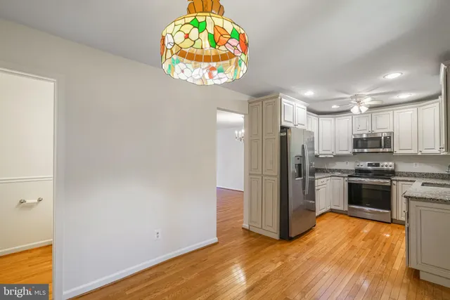 a kitchen with stainless steel appliances a refrigerator and a stove top oven