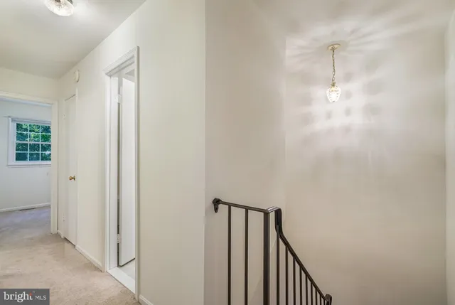 a view of a hallway with wooden floor and entryway