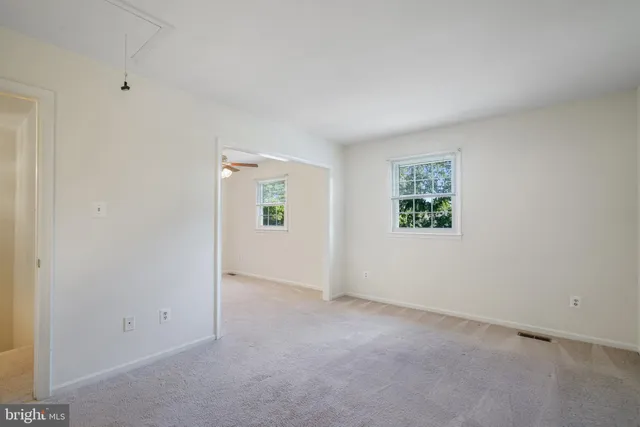 an empty room with windows and closet